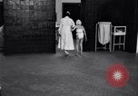 Immagine di Crippled bambino con un infermiere United States USA, 1920, secondo 29 filmato di repertorio 65675028690