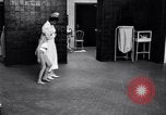 Immagine di Crippled bambino con un infermiere United States USA, 1920, secondo 50 filmato di repertorio 65675028690