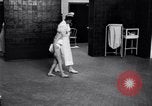 Immagine di Crippled bambino con un infermiere United States USA, 1920, secondo 51 filmato di repertorio 65675028690