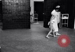 Immagine di Crippled bambino con un infermiere United States USA, 1920, secondo 53 filmato di repertorio 65675028690