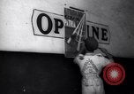 Image of Government's Oil Posters pasted on other companies oil posters Mexico, 1938, second 55 stock footage video 65675028791
