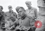 Image of US-Russian soldiers listen guitar Kaesong Korea 38th Parallel, 1945, second 50 stock footage video 65675028819