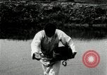 Standbild koreanischen Bauern streut Samen in Reis Bereich Korea, 1936, aus Sekunde 49 historischem Filmmaterial Videoclip 65675028844