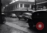Image of cars moving in heavy rain Saigon Vietnam, 1955, second 10 stock footage video 65675028887