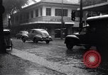 Image of cars moving in heavy rain Saigon Vietnam, 1955, second 11 stock footage video 65675028887
