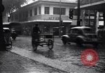 Image of cars moving in heavy rain Saigon Vietnam, 1955, second 14 stock footage video 65675028887