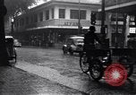 Image of cars moving in heavy rain Saigon Vietnam, 1955, second 15 stock footage video 65675028887