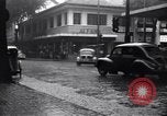 Image of cars moving in heavy rain Saigon Vietnam, 1955, second 16 stock footage video 65675028887