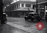 Image of cars moving in heavy rain Saigon Vietnam, 1955, second 20 stock footage video 65675028887