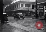 Image of cars moving in heavy rain Saigon Vietnam, 1955, second 21 stock footage video 65675028887