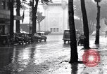 Image of cars moving in heavy rain Saigon Vietnam, 1955, second 34 stock footage video 65675028887