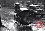 Image of cars moving in heavy rain Saigon Vietnam, 1955, second 49 stock footage video 65675028887