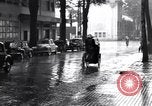 Image of cars moving in heavy rain Saigon Vietnam, 1955, second 57 stock footage video 65675028887