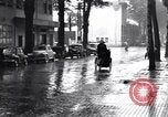 Image of cars moving in heavy rain Saigon Vietnam, 1955, second 58 stock footage video 65675028887
