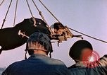 Image of Iwo Jima wounded hoisted onto LST Iwo Jima, 1945, second 49 stock footage video 65675029321