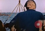 Image of Iwo Jima wounded hoisted onto LST Iwo Jima, 1945, second 54 stock footage video 65675029321