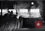 Image of drawing steel rod through die into wires at factory United States USA, 1924, second 52 stock footage video 65675029554