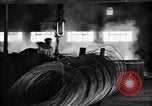 Image of drawing steel rod through die into wires at factory United States USA, 1924, second 53 stock footage video 65675029554