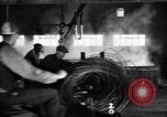 Image of drawing steel rod through die into wires at factory United States USA, 1924, second 54 stock footage video 65675029554