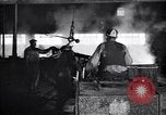 Image of drawing steel rod through die into wires at factory United States USA, 1924, second 57 stock footage video 65675029554