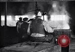 Image of drawing steel rod through die into wires at factory United States USA, 1924, second 60 stock footage video 65675029554