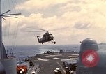 Image of HUS1 UH-34D Seahorse lands on USS North Hampton Atlantic Ocean, 1962, second 19 stock footage video 65675030397