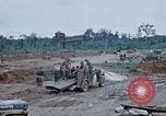 Image of bulldozer levels ground at Fire Base Myron Cambodia, 1970, second 54 stock footage video 65675030461