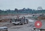 Image of bulldozer levels ground at Fire Base Myron Cambodia, 1970, second 55 stock footage video 65675030461