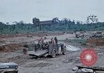 Image of bulldozer levels ground at Fire Base Myron Cambodia, 1970, second 57 stock footage video 65675030461