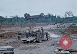 Image of bulldozer levels ground at Fire Base Myron Cambodia, 1970, second 58 stock footage video 65675030461