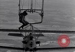 Image N2Y-1 avion d'entraînement des crochets sur et est hissé à bord de l'USS Akron United States USA, 1932, de la seconde 44 séquences d'archives historiques vidéo 65675031703