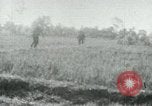 Image of Viet Cong watching U.S. soldiers in Jeep Vietnam, 1965, second 1 stock footage video 65675032686