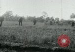 Image of Viet Cong watching U.S. soldiers in Jeep Vietnam, 1965, second 3 stock footage video 65675032686