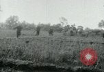 Image of Viet Cong watching U.S. soldiers in Jeep Vietnam, 1965, second 4 stock footage video 65675032686