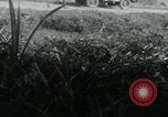Image of Viet Cong watching U.S. soldiers in Jeep Vietnam, 1965, second 18 stock footage video 65675032686