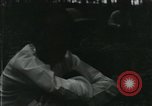 Image of Vietnamese people leaving a damaged Viet Cong camp Vietnam, 1965, second 3 stock footage video 65675032689