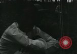 Image of Vietnamese people leaving a damaged Viet Cong camp Vietnam, 1965, second 4 stock footage video 65675032689