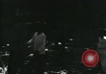 Image of Vietnamese people leaving a damaged Viet Cong camp Vietnam, 1965, second 6 stock footage video 65675032689