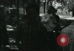 Image of Vietnamese people leaving a damaged Viet Cong camp Vietnam, 1965, second 14 stock footage video 65675032689