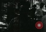 Image of Vietnamese people leaving a damaged Viet Cong camp Vietnam, 1965, second 15 stock footage video 65675032689