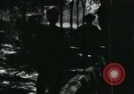Image of Vietnamese people leaving a damaged Viet Cong camp Vietnam, 1965, second 16 stock footage video 65675032689