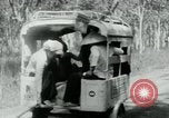 Image of Vietnamese people leaving a damaged Viet Cong camp Vietnam, 1965, second 23 stock footage video 65675032689