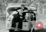 Image of Vietnamese people leaving a damaged Viet Cong camp Vietnam, 1965, second 24 stock footage video 65675032689