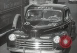 Image of New York City police car driving in midtown Manhattan New York City USA, 1939, second 29 stock footage video 65675032802