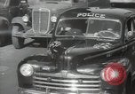 Image of New York City police car driving in midtown Manhattan New York City USA, 1939, second 32 stock footage video 65675032802