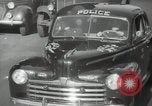 Image of New York City police car driving in midtown Manhattan New York City USA, 1939, second 33 stock footage video 65675032802