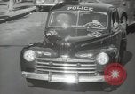 Image of New York City police car driving in midtown Manhattan New York City USA, 1939, second 37 stock footage video 65675032802
