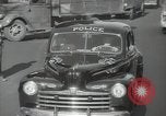 Image of New York City police car driving in midtown Manhattan New York City USA, 1939, second 41 stock footage video 65675032802