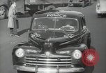 Image of New York City police car driving in midtown Manhattan New York City USA, 1939, second 42 stock footage video 65675032802