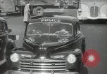 Image of New York City police car driving in midtown Manhattan New York City USA, 1939, second 44 stock footage video 65675032802
